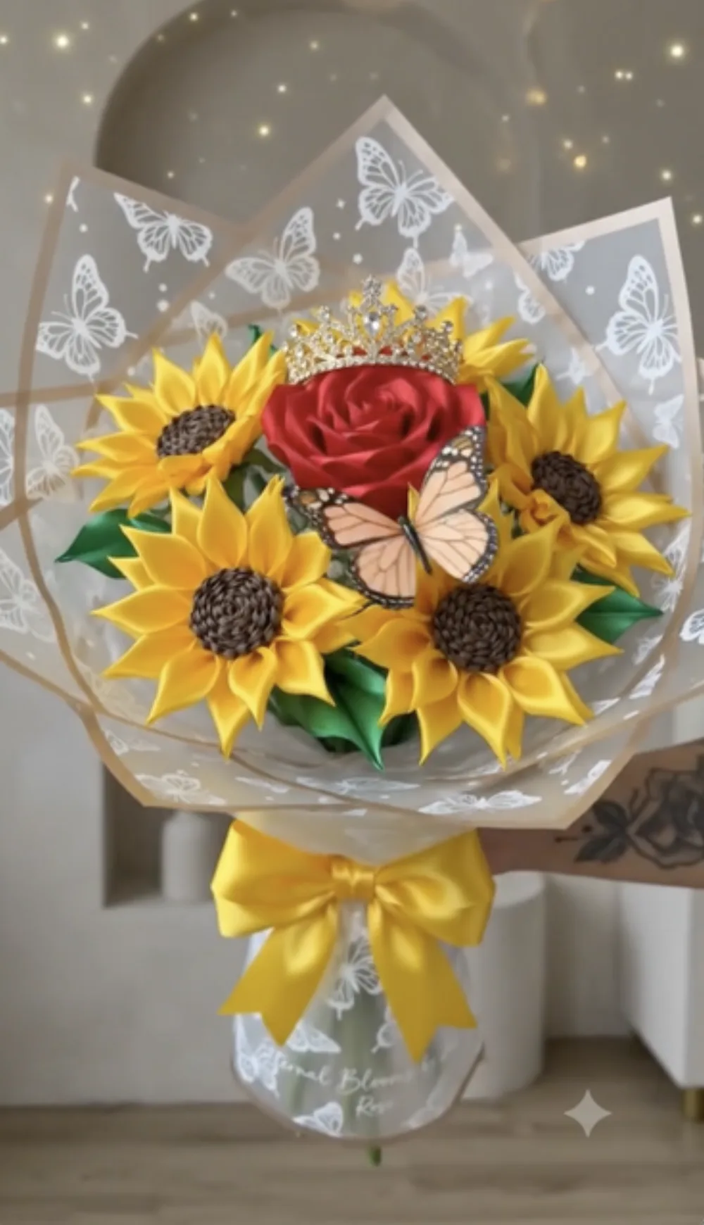 Wrapped bouquet with a crowned red satin rose and satin sunflowers